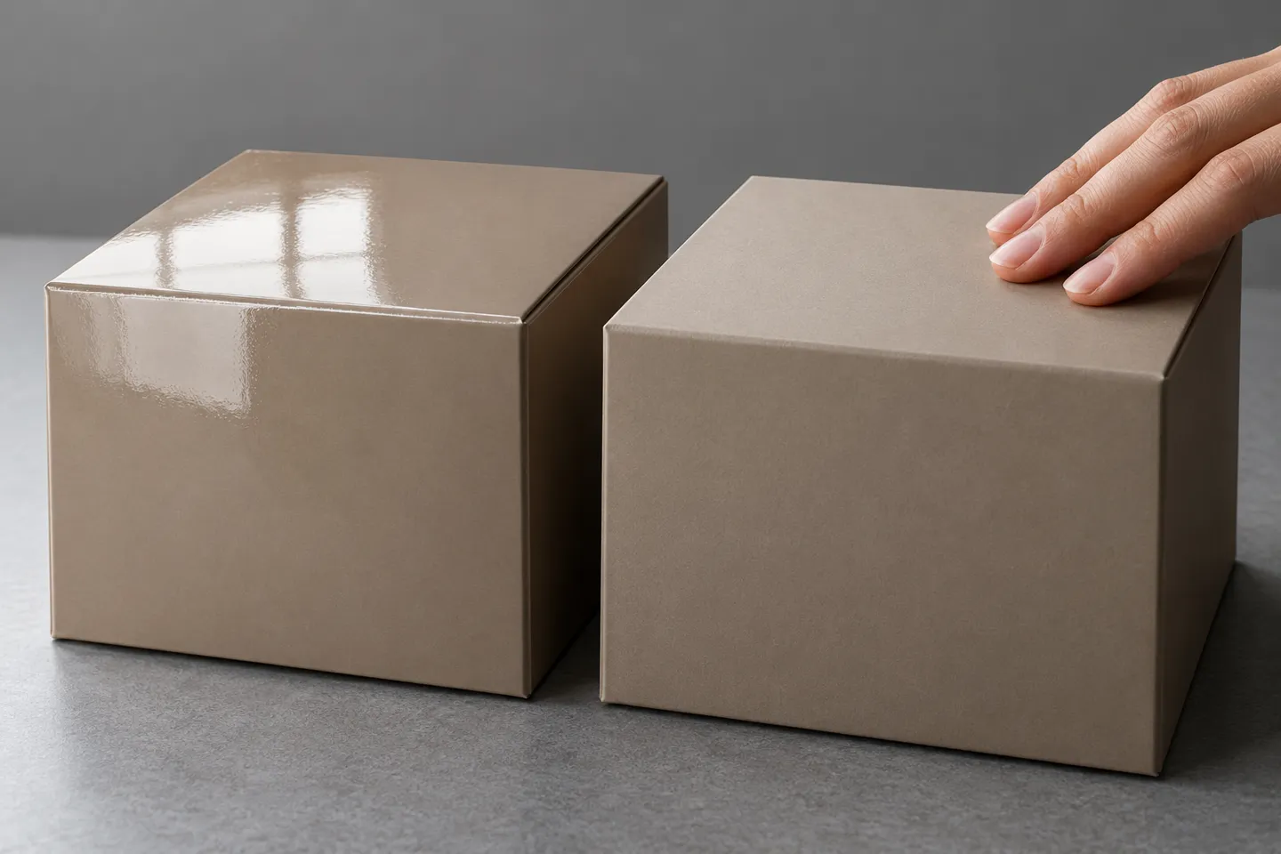 Two identical boxes compared side by side, one covered in high-gloss BOPP lamination film and one in matte film, showing how the finish changes what a package reads like on a shelf.